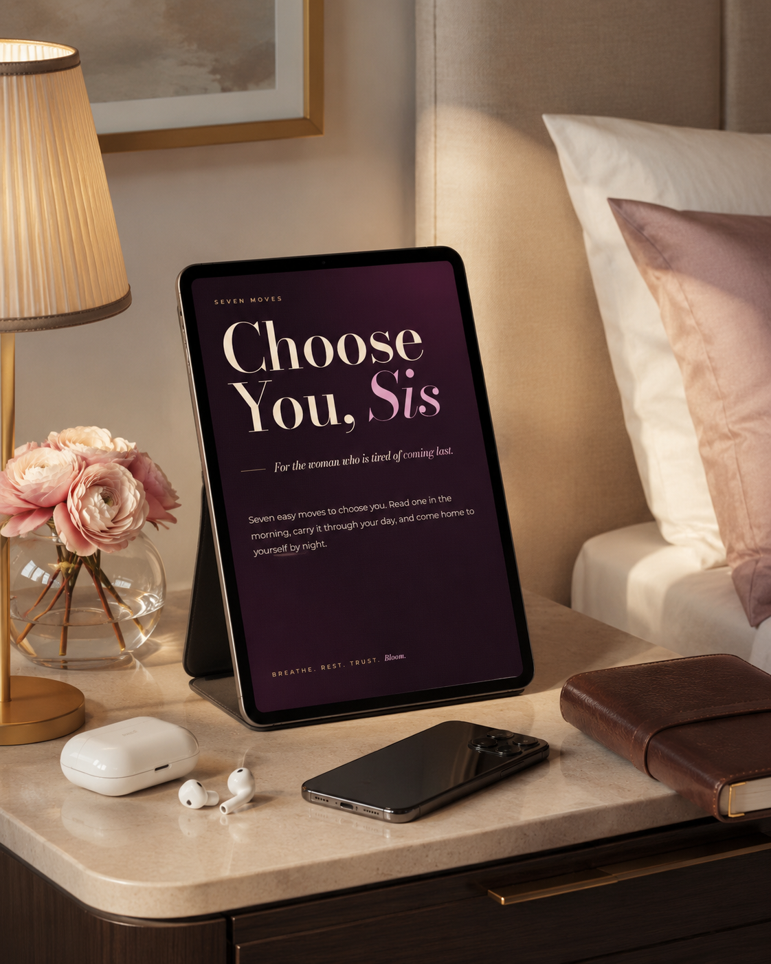 Choose You, Sis: the BLOOM digital gift on a tablet beside earbuds on a nightstand